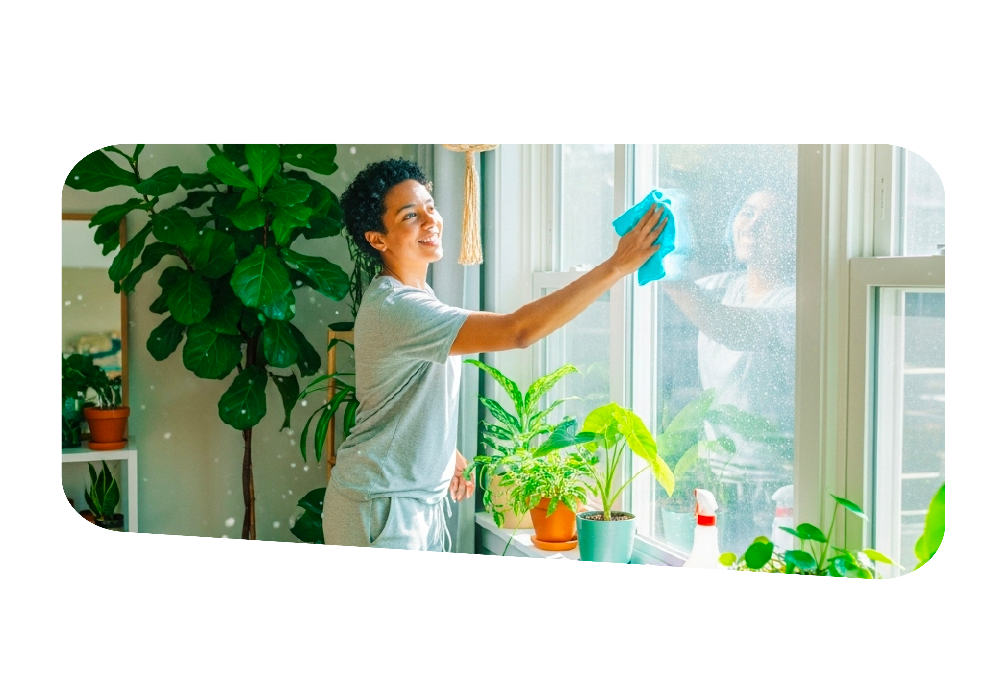 Person cleaning a bright window, representing spring cleaning.